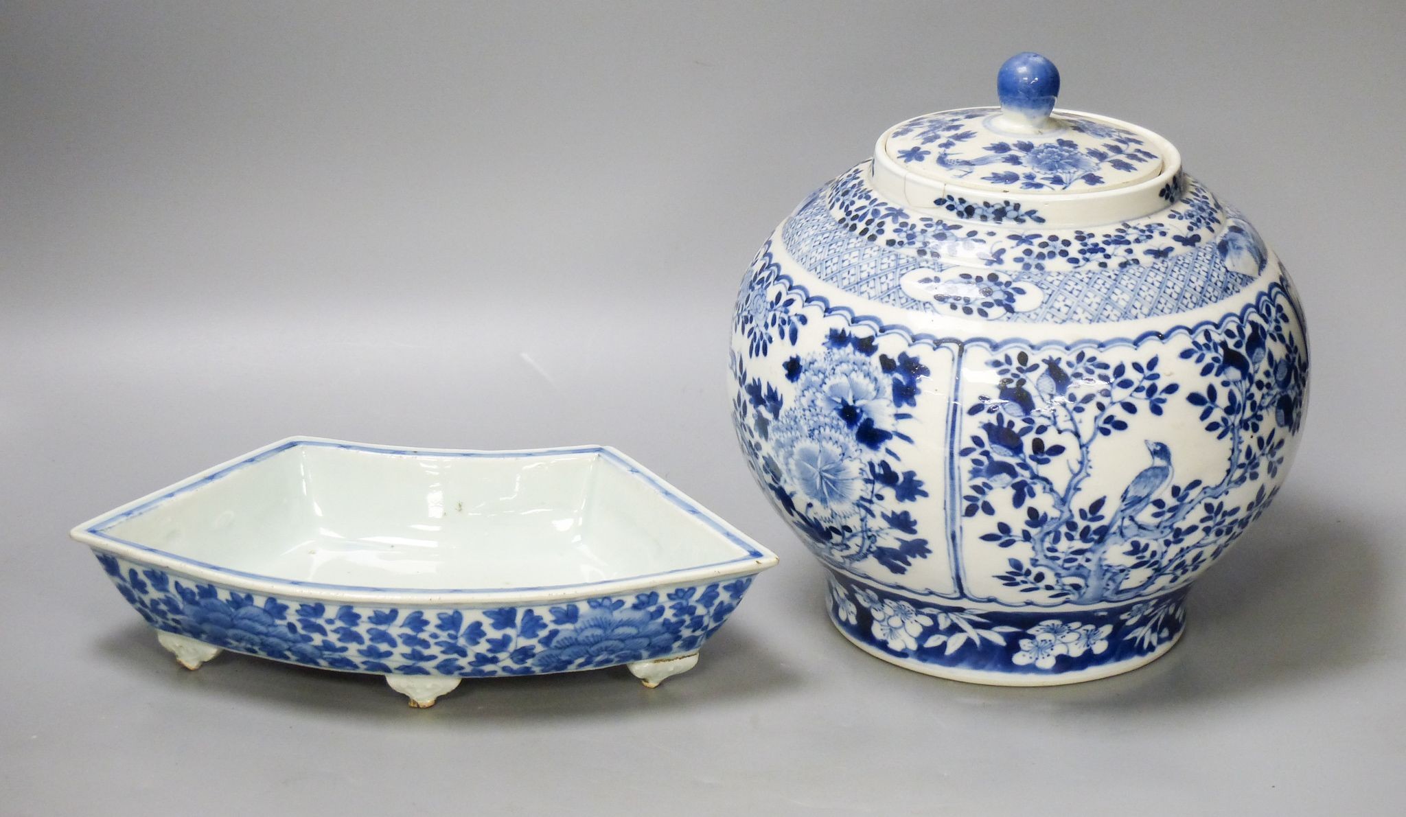 A 19th century Chinese blue and white jar and cover, four character Kangxi mark, 22cm high and a Chinese blue and white fan shape dish, 25.5cm